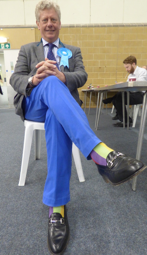 Trousers suitably blue contrasting with multi-coloured, odour free socks, a victorious Stephen Mansbridge sportingly poses for The Guildford Dragon News.
